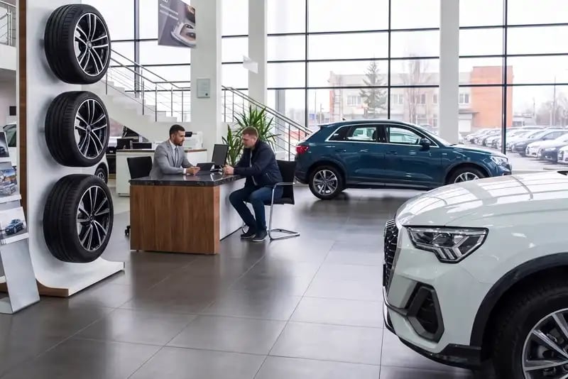 New white car being sold in dealership