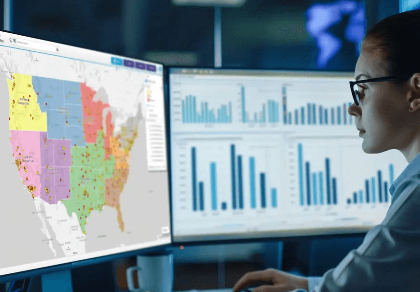 Data analyst viewing territory map on computer screen