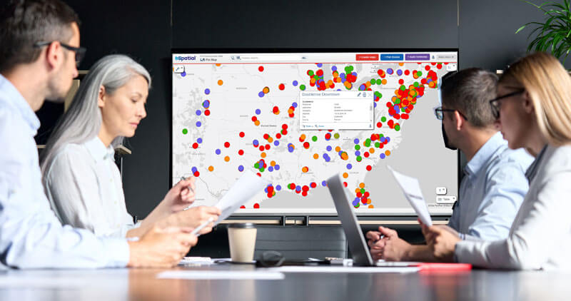 Marketing team viewing pin map on screen