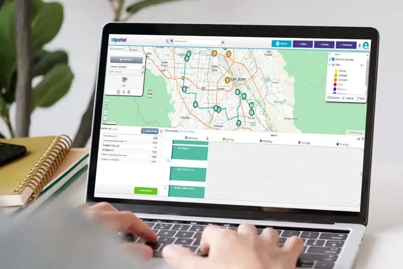 Person using eSpatial route planning on a laptop
