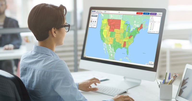 Person looking at monitor with US state regional heat map