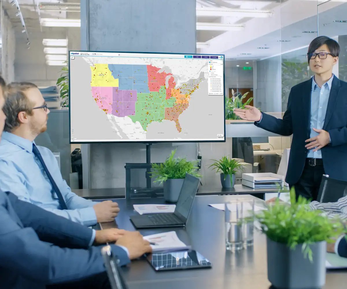 Team meeting with person presenting territory map