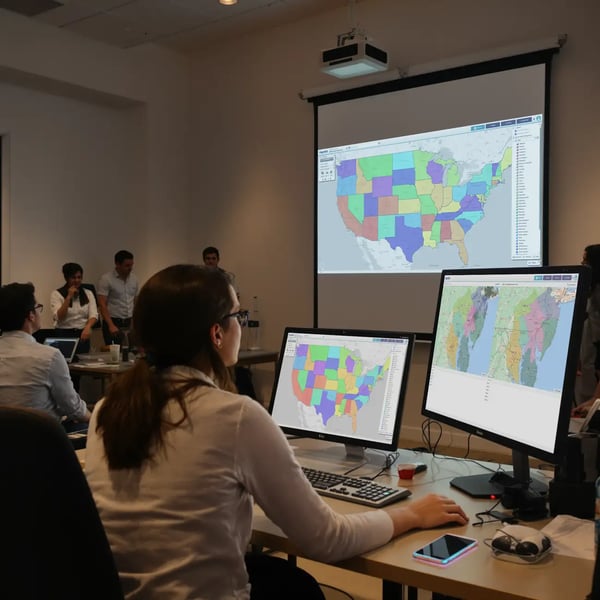 Team reviewing territory maps on a projector